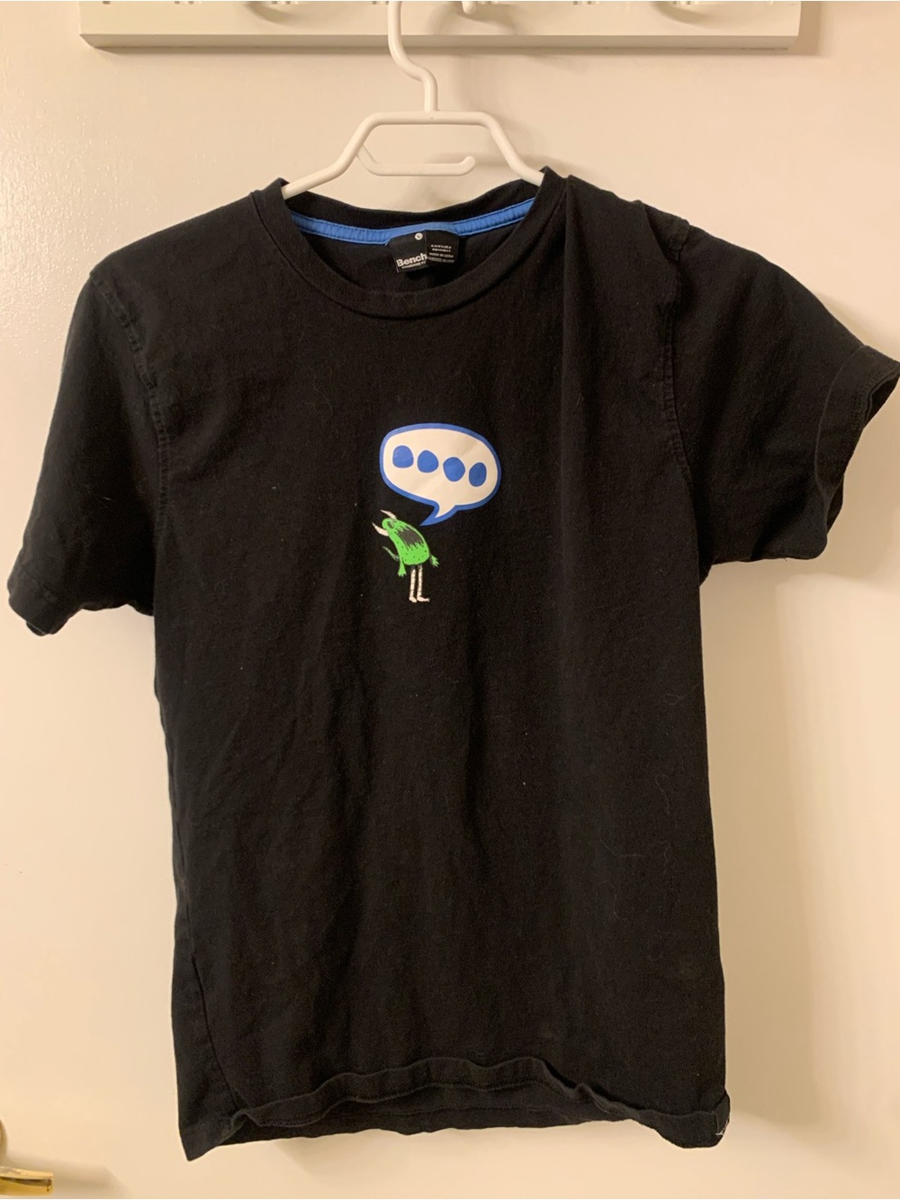Black Graphic Tee with Green Bird Speech Bubble